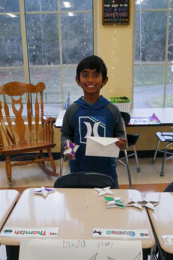 boy holding up envelope